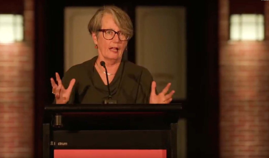 Judith Brett speaking at the podium.